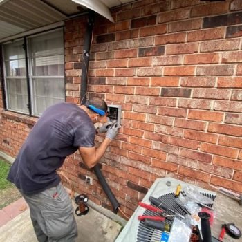 Professional AC installation New Orleans technician setting up central air unit